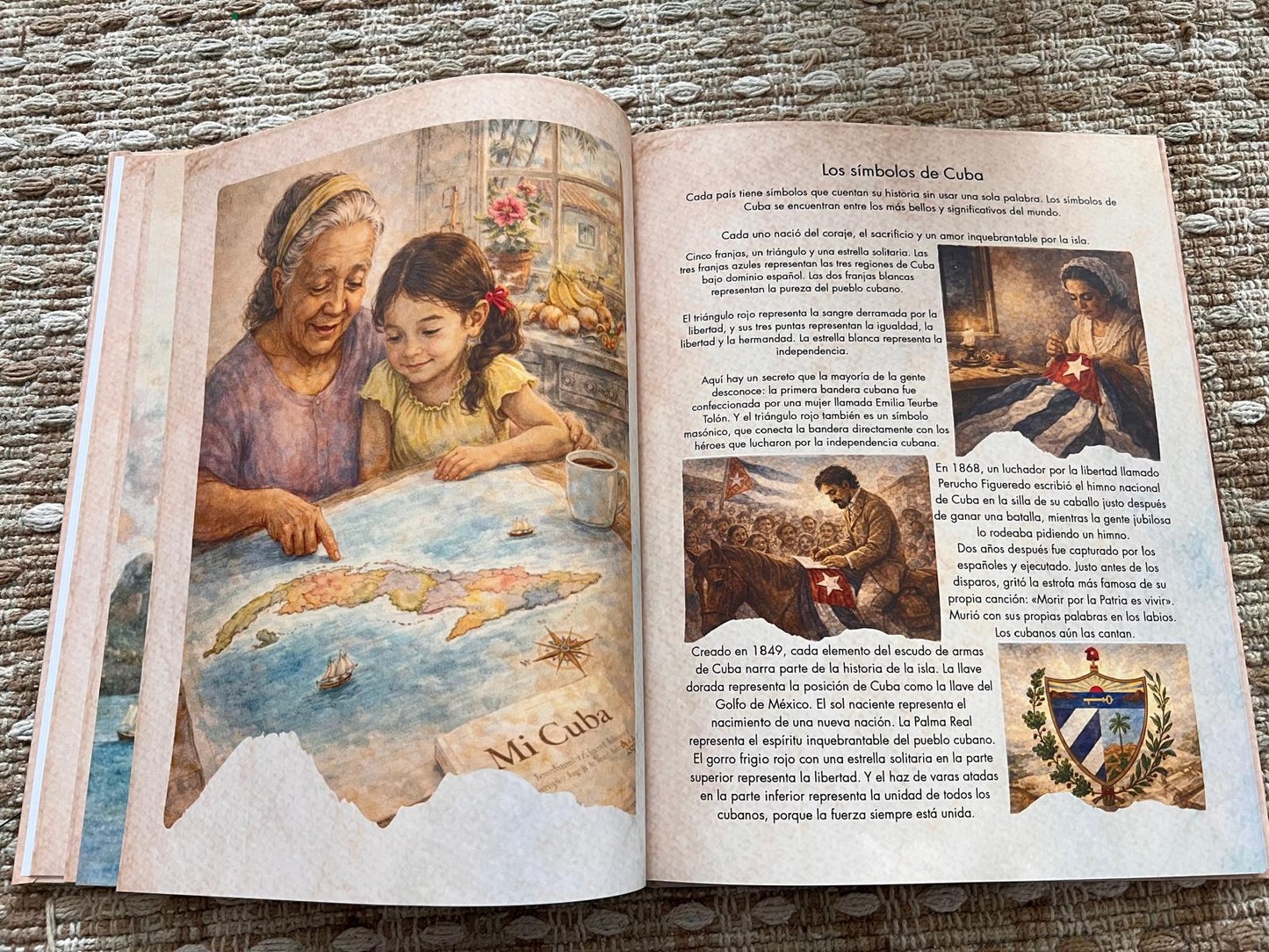 Open book with illustrations and text on a textured surface with symbols of Cuba